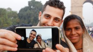 Tourist taking a selfie with a Local Woman in India Gate, New Delhi_570812749